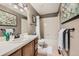 Traditional bathroom with a combination shower and tub, white fixtures, and a framed art collection at 17509 E Kenyon Dr, Aurora, CO 80013