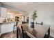 Inviting dining room next to a kitchen, with a dark wood table and chairs at 17509 E Kenyon Dr, Aurora, CO 80013