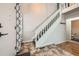 Welcoming entryway with tile flooring, stairs with white railings, and a glimpse of a nearby bathroom at 17509 E Kenyon Dr, Aurora, CO 80013