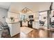 Well-lit kitchen with stainless steel appliances, granite countertops, and white cabinets at 17509 E Kenyon Dr, Aurora, CO 80013