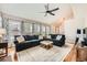 Inviting living room with a plush sofa, stylish rug, lots of natural light and a ceiling fan at 17509 E Kenyon Dr, Aurora, CO 80013