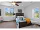 Bright bedroom with large windows, dark wood bed frame, and stylish decor at 3275 W Hawthorne Pl, Denver, CO 80221