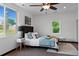 Sunlit bedroom with a cozy bed, modern decor, and two windows offering lovely views at 3275 W Hawthorne Pl, Denver, CO 80221