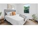 Comfortable bedroom with a large window, plush bedding, and modern decor at 3275 W Hawthorne Pl, Denver, CO 80221