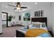Spacious bedroom featuring a ceiling fan, large window, modern decor, and stylish furnishings at 3275 W Hawthorne Pl, Denver, CO 80221