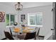 Inviting dining area with natural light, modern chairs, and glass table for elegant dining at 3275 W Hawthorne Pl, Denver, CO 80221