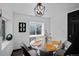 Well-lit dining room features round glass table with seating for six and stylish decor at 3275 W Hawthorne Pl, Denver, CO 80221