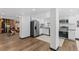 Bright kitchen features stainless steel appliances, granite countertops, and white cabinetry at 3275 W Hawthorne Pl, Denver, CO 80221