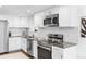 Modern kitchen features stainless appliances, granite countertops, and white subway tile backsplash at 3275 W Hawthorne Pl, Denver, CO 80221