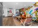 Stylish living room with unique wall art, hardwood floors, and modern furniture at 3275 W Hawthorne Pl, Denver, CO 80221