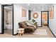 Basement living room with a brown futon, soft rug, and stylish decor at 3275 W Hawthorne Pl, Denver, CO 80221