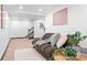 Basement living room with a comfortable brown futon, soft lighting, and stylish decorations at 3275 W Hawthorne Pl, Denver, CO 80221