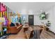 Bright living room with hardwood floors, funky wall art, and contemporary decor at 3275 W Hawthorne Pl, Denver, CO 80221