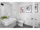 Modern bathroom features a floating sink, minimalist fixtures, and decoratively framed pictures at 3040 Wilson Ct # 2, Denver, CO 80205