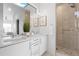 Bright bathroom featuring double vanity sinks, a full-width mirror, and glass enclosed shower at 3040 Wilson Ct # 2, Denver, CO 80205