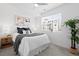 Bright bedroom features a ceiling fan, window with blinds, and coordinated decor in neutral tones at 3040 Wilson Ct # 2, Denver, CO 80205