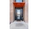 Close-up of a modern front door with a black frame and orange awning at 3040 Wilson Ct # 2, Denver, CO 80205