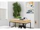 Bright home office featuring a modern desk, accent stool, and decorative tree at 3040 Wilson Ct # 2, Denver, CO 80205