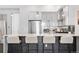 Bright kitchen featuring white cabinets, stainless steel appliances, a breakfast bar, and modern pendant lighting at 3040 Wilson Ct # 2, Denver, CO 80205