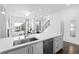 Modern kitchen with white countertops and cabinets, and stainless steel appliances, flowing into the living room area at 3040 Wilson Ct # 2, Denver, CO 80205