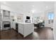 Bright, open-concept kitchen and living room with sleek white cabinets, stainless steel appliances, and modern finishes at 3040 Wilson Ct # 2, Denver, CO 80205