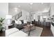 Bright living room with modern furnishings, open floor plan, and a view of the kitchen and staircase at 3040 Wilson Ct # 2, Denver, CO 80205