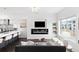 Open-concept living space with modern fireplace, TV, breakfast bar, and ample seating for entertaining and relaxation at 3040 Wilson Ct # 2, Denver, CO 80205