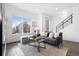 Bright living room with a large window, contemporary furniture, and hardwood floors at 3040 Wilson Ct # 2, Denver, CO 80205