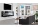 Stylish living room featuring a modern fireplace, sleek built-ins, a comfortable sofa, and bright natural light at 3040 Wilson Ct # 2, Denver, CO 80205