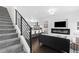 Open living space with modern fireplace, hardwood floors, and access to the kitchen at 3040 Wilson Ct # 2, Denver, CO 80205