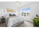 Cozy bedroom with ample natural light, a plush bed, and modern decor at 3040 Wilson Ct # 2, Denver, CO 80205