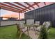 Inviting outdoor seating area with artificial turf, stylish furniture, and a pergola, perfect for relaxing and entertaining at 3040 Wilson Ct # 2, Denver, CO 80205