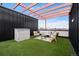 Inviting rooftop patio with artificial turf, lounge furniture, and a pergola, perfect for relaxing and enjoying the outdoors at 3040 Wilson Ct # 2, Denver, CO 80205