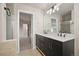 Double vanity bathroom with a view into another room at 5483 S Versailles St, Aurora, CO 80015