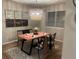 Modern dining room with a wood table, four chairs, and a stylish chandelier at 5483 S Versailles St, Aurora, CO 80015