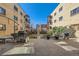 Shared backyard area with patio, barbecue grills, and greenery between buildings at 1175 N Emerson St # 312, Denver, CO 80218