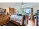 Cozy bedroom with a ceiling fan, large window, and wood accents at 1175 N Emerson St # 312, Denver, CO 80218