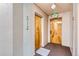 Hallway featuring unit door, exit door and a carpeted floor at 1175 N Emerson St # 312, Denver, CO 80218