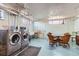 Laundry room with modern washer and dryer, sink, and table with chairs at 1175 N Emerson St # 312, Denver, CO 80218