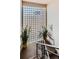 Stairwell with a large glass block window and ornamental light fixture, potted plants and metal railing at 1175 N Emerson St # 312, Denver, CO 80218