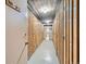 Hallway with several wooden storage units and concrete flooring at 1175 N Emerson St # 312, Denver, CO 80218