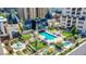 An aerial view showcasing a luxurious pool and garden area surrounded by elegant architecture in an urban setting at 925 N Lincoln St # 14C, Denver, CO 80203