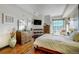 Spacious main bedroom featuring hardwood floors, natural light, and serene cityscape views at 925 N Lincoln St # 14C, Denver, CO 80203