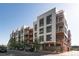 Modern apartment building featuring balconies, large windows, and brick and metal facade at 3100 Huron St # 1B, Denver, CO 80202