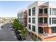 Contemporary apartment complex with balconies, modern facade, and street parking at 3100 Huron St # 1B, Denver, CO 80202