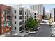 Modern apartment building with balconies, large windows, and street parking in urban setting at 3100 Huron St # 1B, Denver, CO 80202