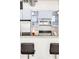 Modern kitchen with stainless steel appliances, white backsplash, and bar seating at 3100 Huron St # 1B, Denver, CO 80202