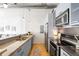 Close-up shot of the kitchen with stainless steel appliances and light gray cabinets at 3100 Huron St # 1B, Denver, CO 80202