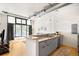 Modern kitchen with stainless steel appliances and gray cabinets, open to the living room at 3100 Huron St # 1B, Denver, CO 80202