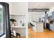 Modern kitchen featuring stainless steel appliances and bar seating adjacent to a desk area at 3100 Huron St # 1B, Denver, CO 80202